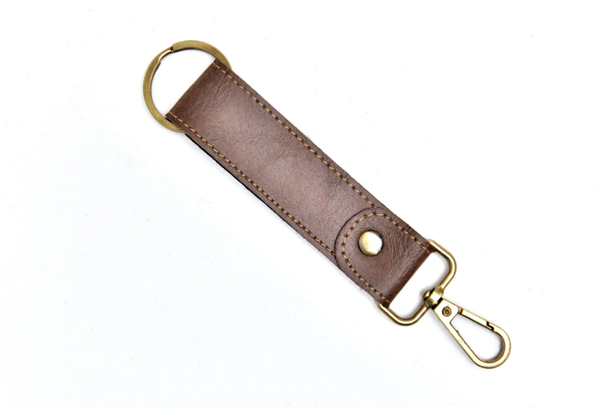 "The sleek, modern design of this leather keychain adds a touch of sophistication to your everyday carry. "